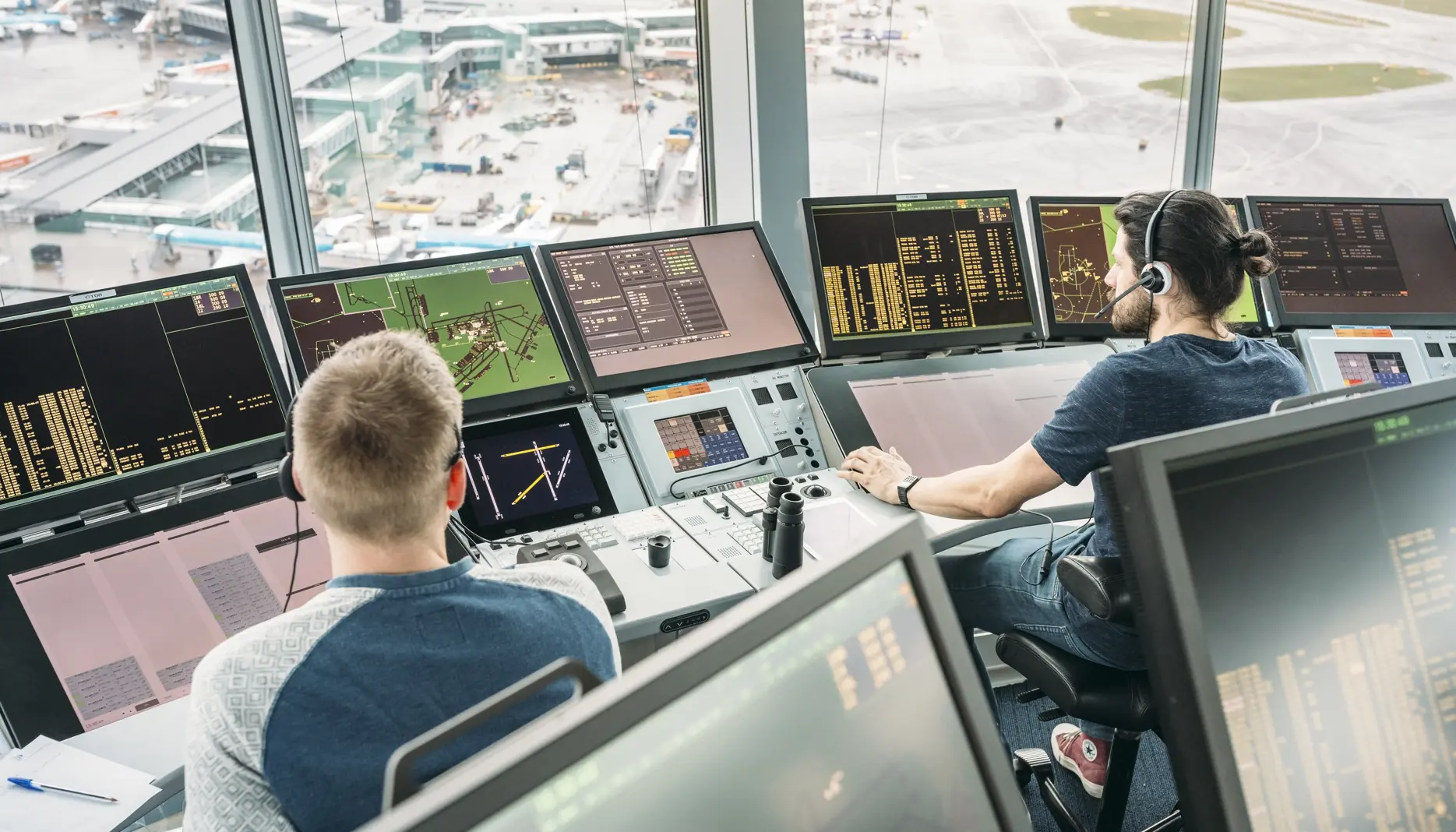 Air traffic controllers handle air traffic from the tower at Schiphol